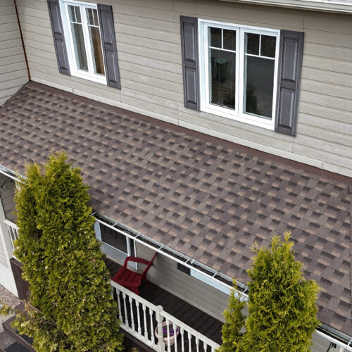 Vue aérienne d'une maison résidentielle avec une nouvelle toiture réalisée par Zoom Toiture, utilisant des matériaux GAF. Maison résidentielle, beige, noir, brun, Québec